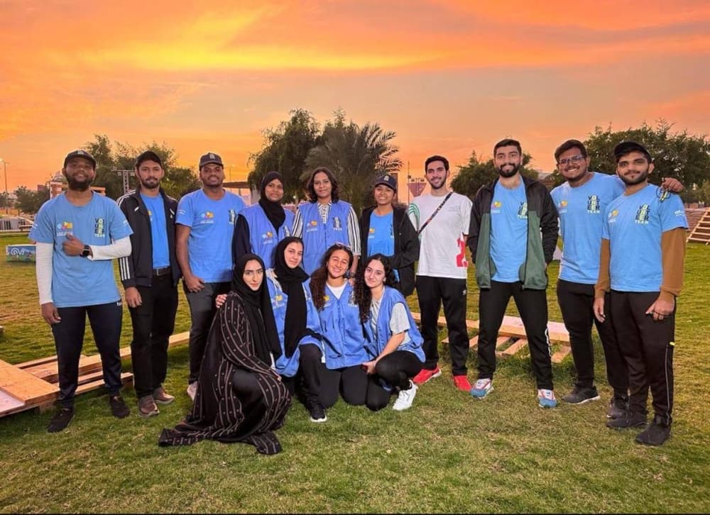 Volunteer team at sunset - diverse group of students and volunteers